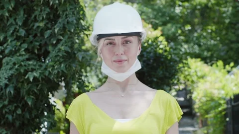 Portrait of female engineer smiling at camera with hard hat and protective vest. Stock Footage 135823419