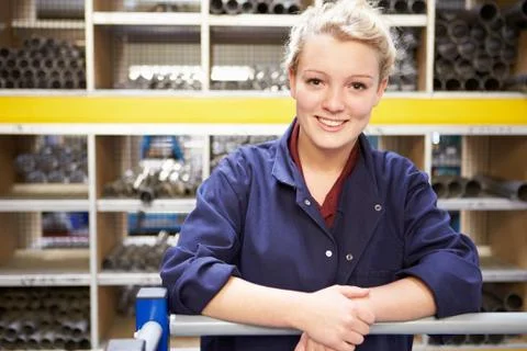 Portrait of female engineering apprentice in store room Stock Photos