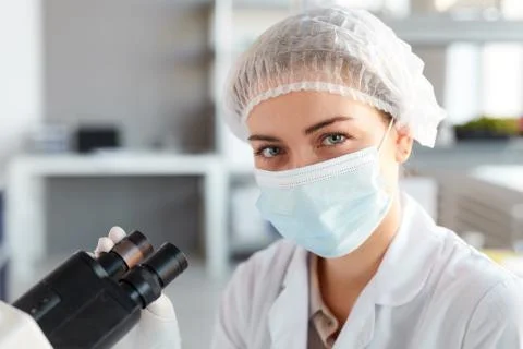 Portrait of Female Medic Using Microscope Stock Photos