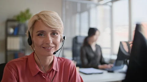 Portrait of Female Operator in Headset Working in Call Center Office 스톡 동영상 335749037