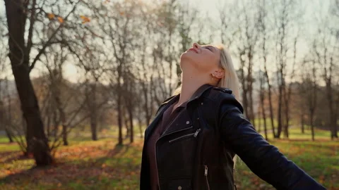 Portrait female person looking at camera in autumn park Stock Footage 164774103