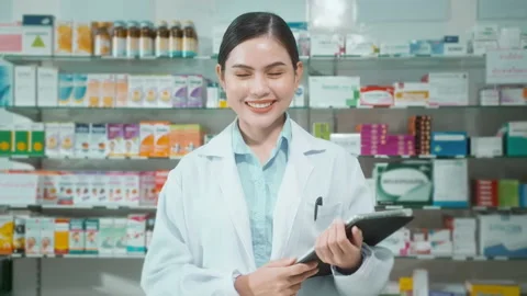 Portrait of female pharmacist using tablet in a modern pharmacy drugstore. Stockbeeldmateriaal 204826993