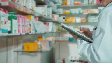 Portrait of female pharmacist using tablet in a modern pharmacy Stock Footage 204827779