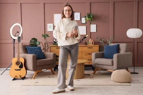 Portrait of female podcaster with tablet computer in studio 库存照片