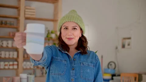 Portrait of Female potter smiling while holding homemade mug in hand 库存影片 221949547