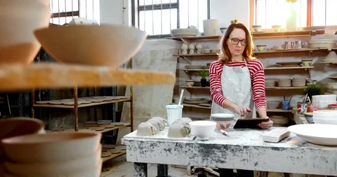 Portrait of female potter using digital tablet 4k Stock Footage 85324518