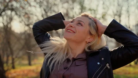 Portrait female smiling looking at camera in autumn park Stock Footage 164775291