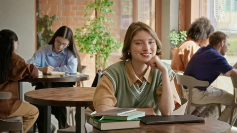 Portrait of Female Student Smiling While Studying in University Library Stock Footage 342121490