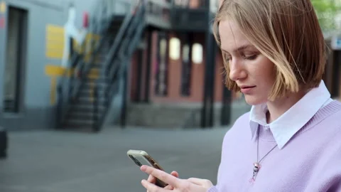 Portrait of female student using smartphone outdoors Видео 157195093