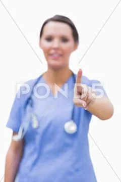 Portrait of female surgeon pointing at invisible screen Stock Photos