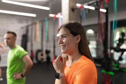 Portrait of a female trainee smiling while resting at the gym Stock Photos