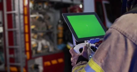 Portrait of firefighter controling drone, looking at scale of fire using drone Stock Footage 137898902