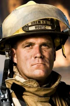 Portrait of a firefighter with fire in background Stock Photos