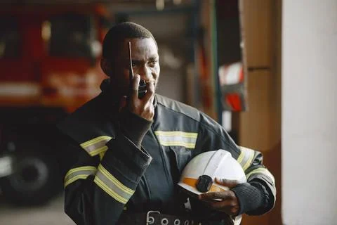 Portrait of a firefighter standing in front of a fire engine Fotos de archivo