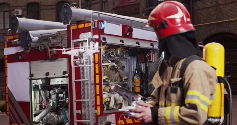 Portrait of firefighter using drone holding control panel in hands to assess Stock Footage 137898861