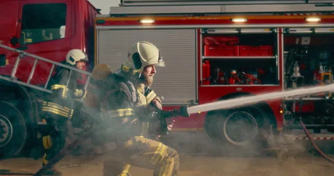 Portrait Firefighter Using Water Hose Stock Footage 295834054