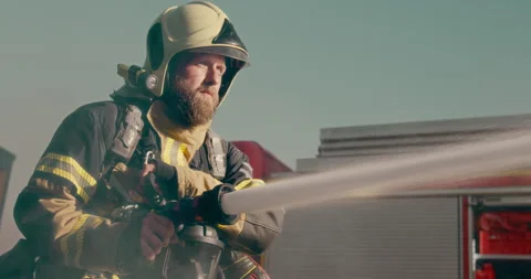 Portrait Firefighter Using Water Hose Stock Footage 295834377