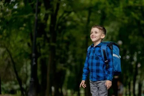 Portrait of a first grader with a backpack. The boy goes to school Stock Photos