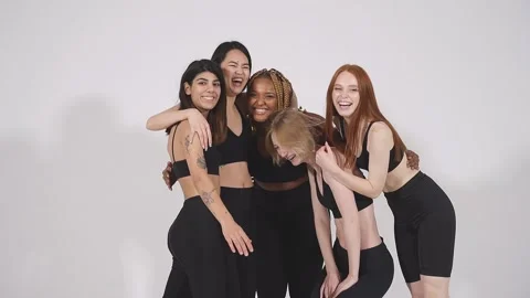 Portrait of five smiling laughing beautiful women in bodysuit standing together Stock Footage 146363860