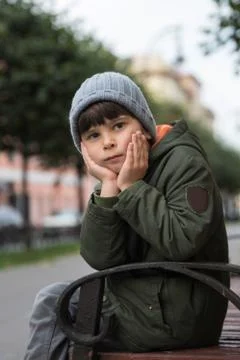 Portrait of a five-year-old boy in the city in the fall. Stock Photos