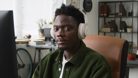 Portrait of Focused Black Male Developer in Headphones Working on Code Stock Footage 335938060
