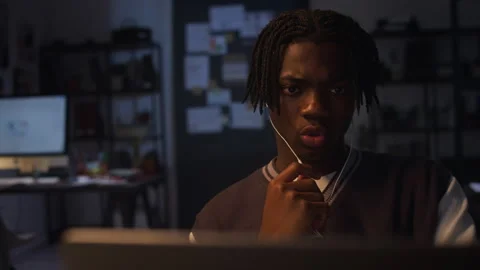 Portrait of Focused Black Man Working Late on Computer in Office Stock Footage 338414631