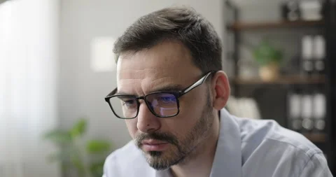 Portrait of focused businessman working looking at laptop screen analyzing stock Stock Footage 277947645