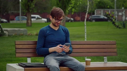 Portrait focused man writing using mobile phone outdoor. Stock Footage 164035979