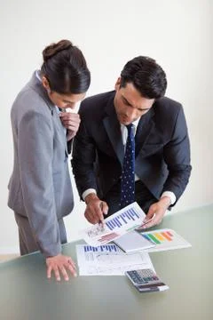 Portrait of focused sales persons studying statistics Stock Photos
