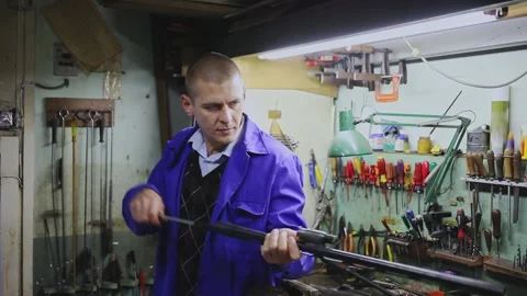 Portrait of focused skilled craftsman of weapons workshop engaged in rifle Stock Footage 165190703