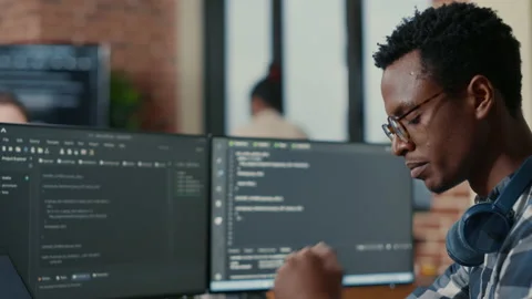 Portrait of focused software developer writing code arranging glasses sitting at Stock Footage 168242517