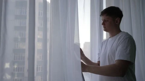 Portrait of focused young man using steam cleaner for curtain cleaning, removing Stock Footage 304882036