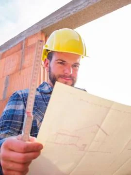 Portrait of foreman with construction plan and pocket rule Stock Photos