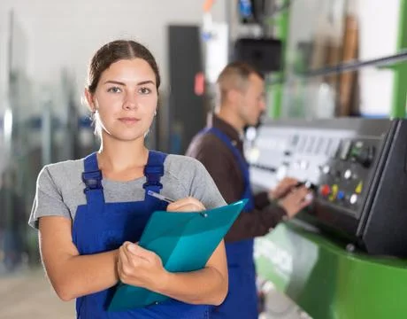 Portrait of foreman girl with folder of documents in glass workshop Stock-Fotos