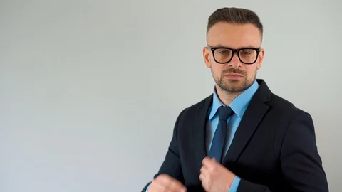 Portrait of a formally dressed bearded man with glasses straightens his tie and Stock Footage 119472648