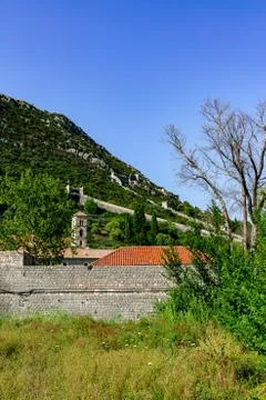 Portrait format of the great old wall of Ston with an old church tower Stock Photos