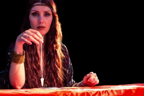 Portrait of fortune teller with pendulum 스톡 사진