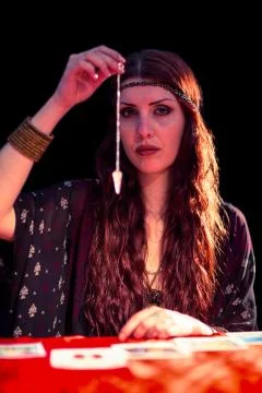 Portrait of fortune teller using pendulum 스톡 사진