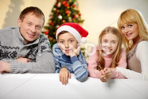 Portrait of four happy family members looking at camera with smiles Stock Photos