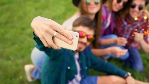 Portrait of four happy hipsters while they making selfie with sparklers  Stock Footage 75765240