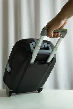 Portrait frame of suitcase being pulled from side view, traveler in motion .. Stock Photos