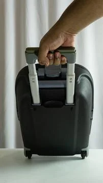 Portrait frame of suitcase being pulled from side view, traveler in motion .. Stock Photos