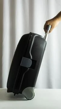 Portrait frame of suitcase being pulled from side view, traveler in motion .. Stock Photos
