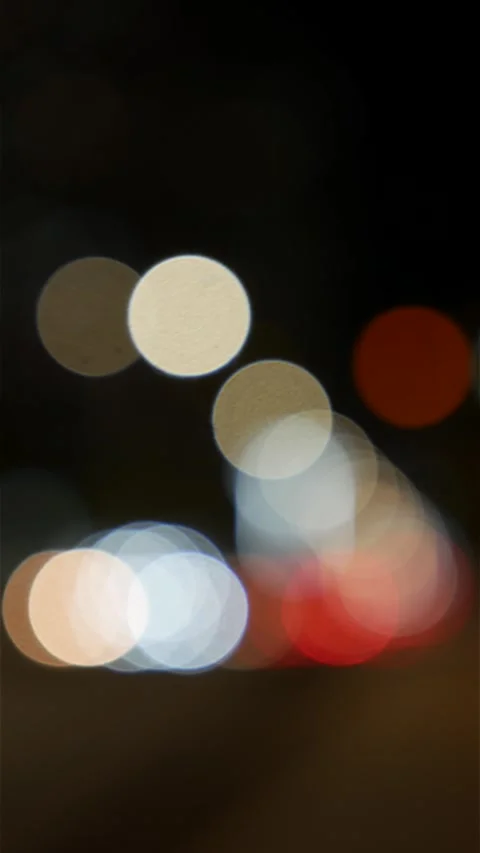 Portrait frame with white headlights and red taillights blending into luminous Stock-Footage 334939785