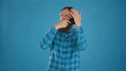 Portrait of a freak guy combing his hair and singing into a comb Stock Footage 127624058