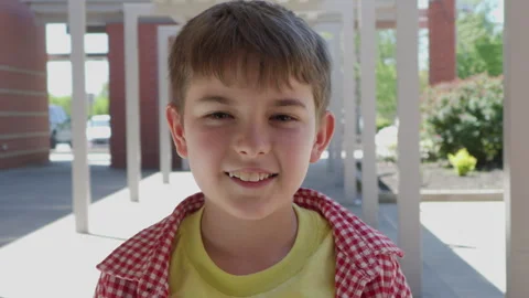 Portrait Friendly Boy Standing Outside Elementary School Building. School B.. Video stock 342618982