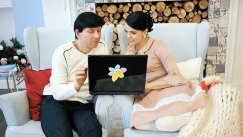 Portrait of a friendly couple having fun on laptop at home indoor Stock Footage 104285033