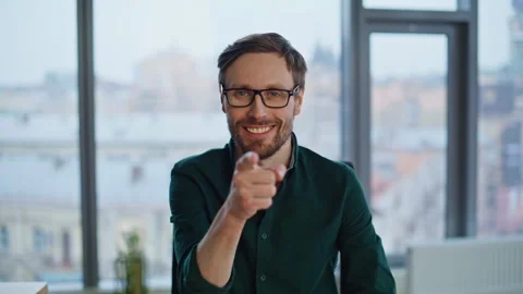 Portrait friendly entrepreneur pointing finger to camera at contemporary office. Stock Footage 315282993