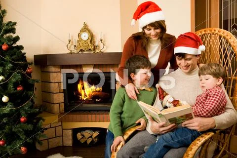 Portrait of friendly family looking into interesting book on christmas day Stock-Fotos