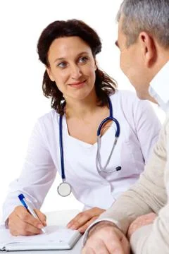 Portrait of friendly therapist looking at senior patient during medical consulta Stock Photos